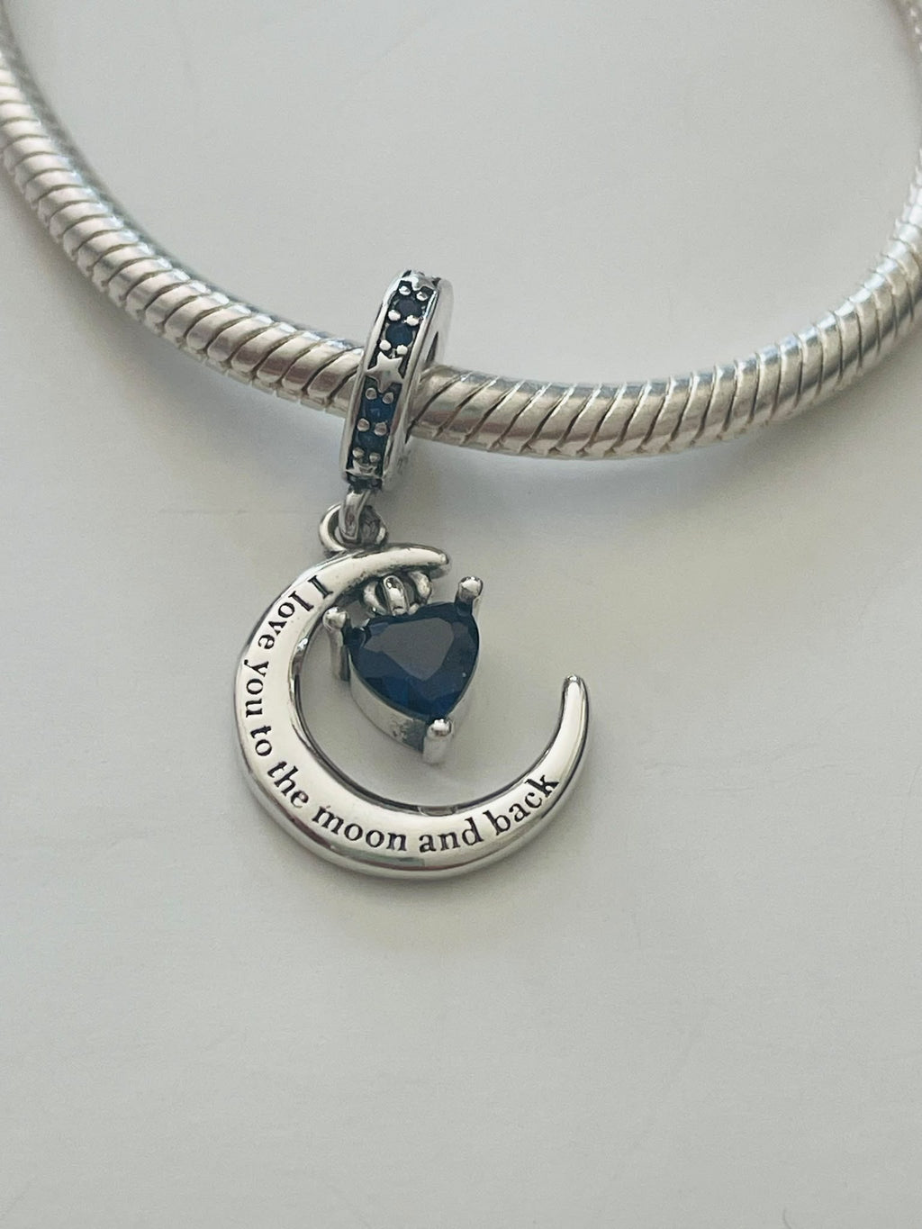 Moon and back charm front view on bracelet