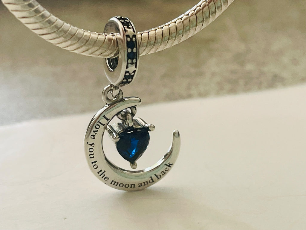 Moon and back dangle charm hanging on silver bracelet