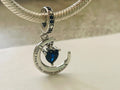 Moon and back dangle charm hanging on silver bracelet