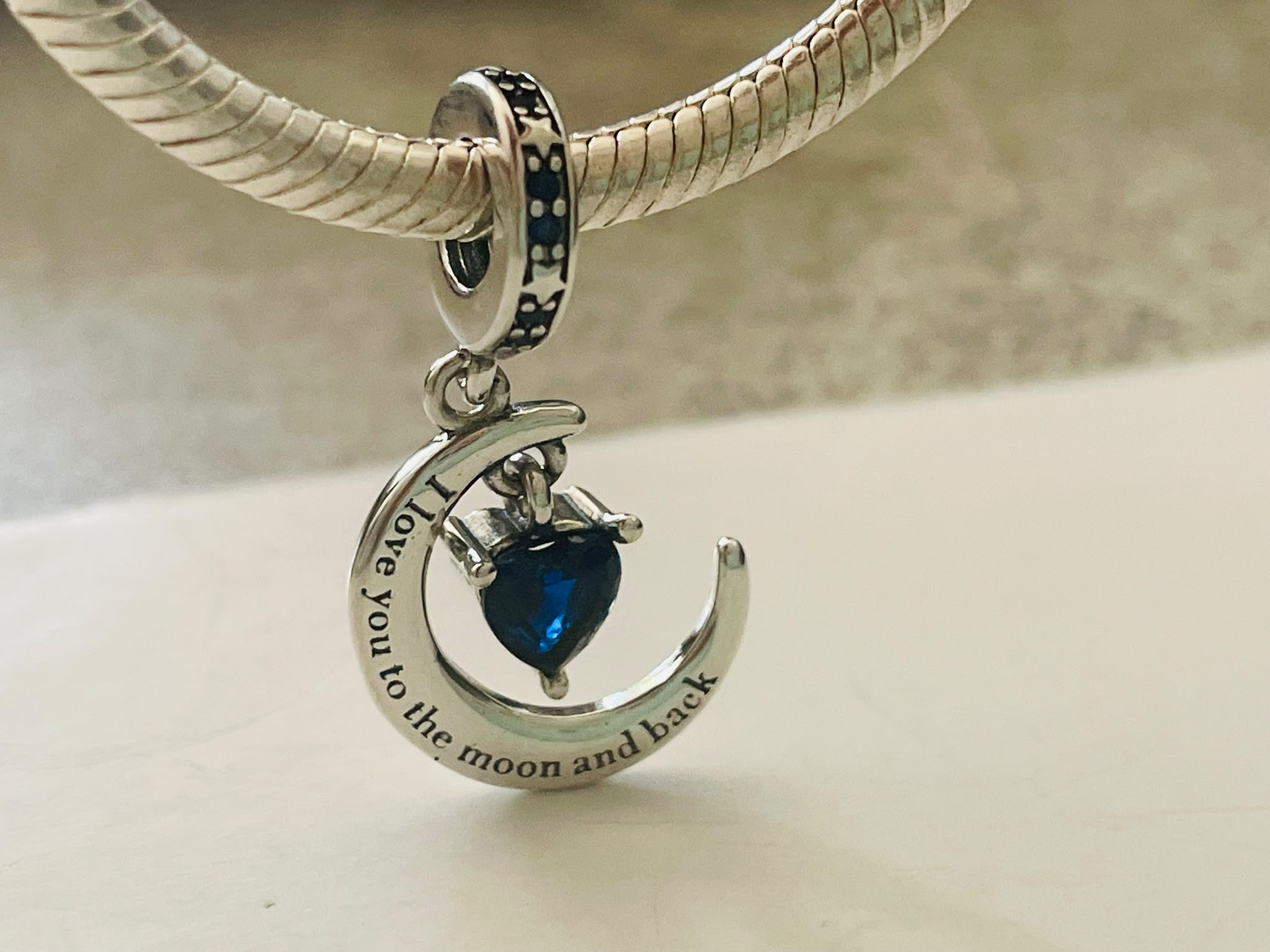 Moon and back dangle charm hanging on silver bracelet